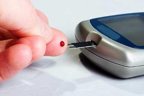 DieticiansCorner-WhyIsBloodSugarControlImportant-2016-04-17 Blood glucose test with a drop of blood on a test strip