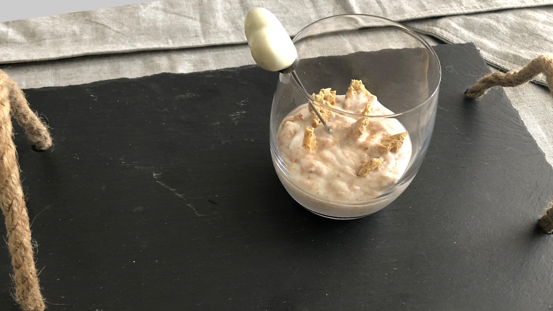 Glass of milk tart yogurt with biscuit pieces on top