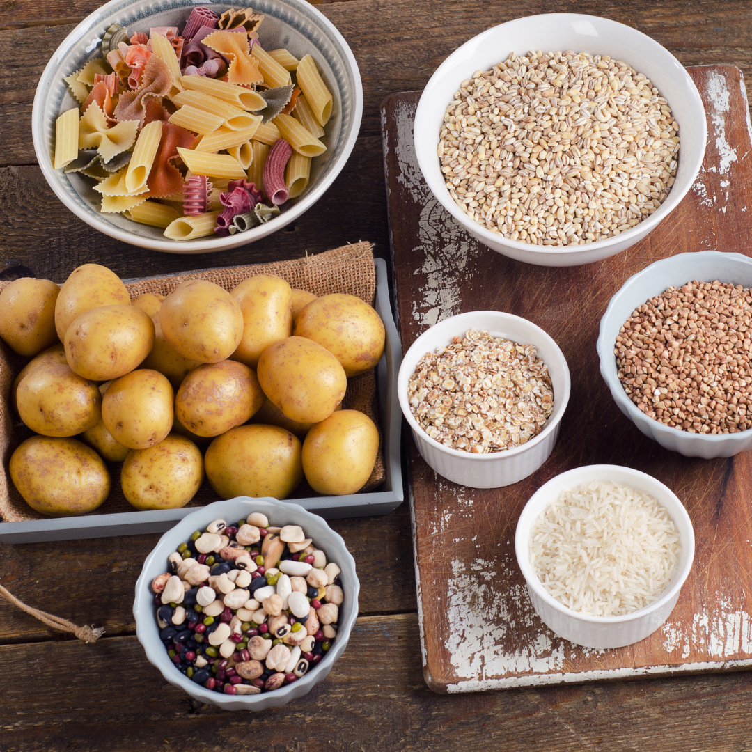 what carbs should you eat to lose belly fat A table stacked with different types of carbs.
